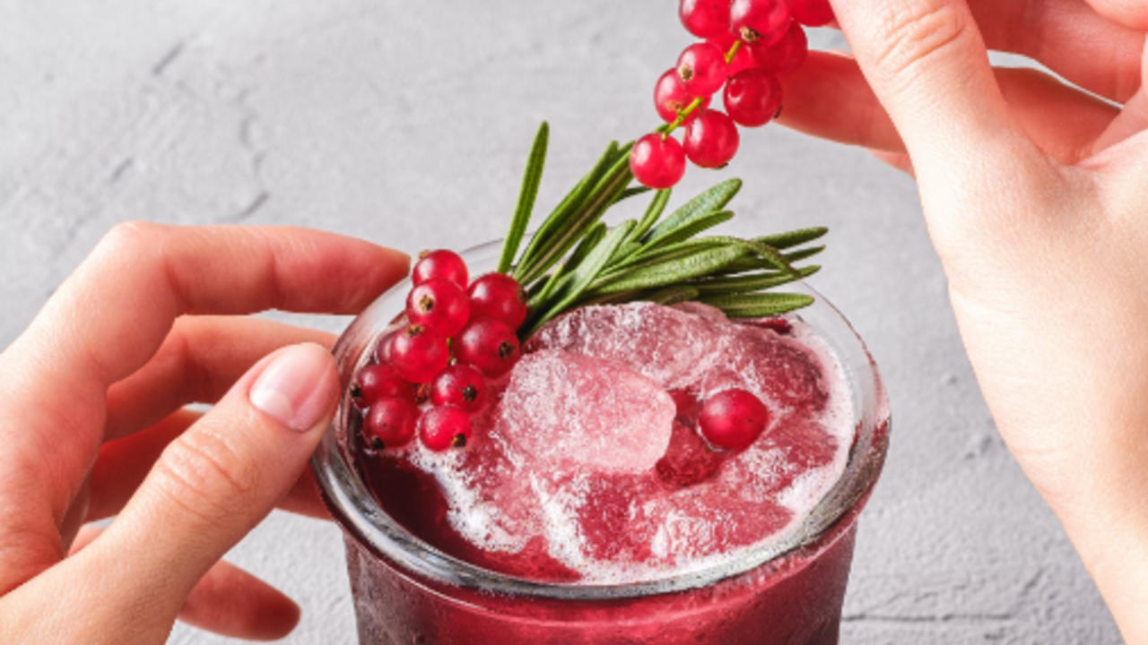 red-cocktail-with-rosemary-and-cranberry-garnish