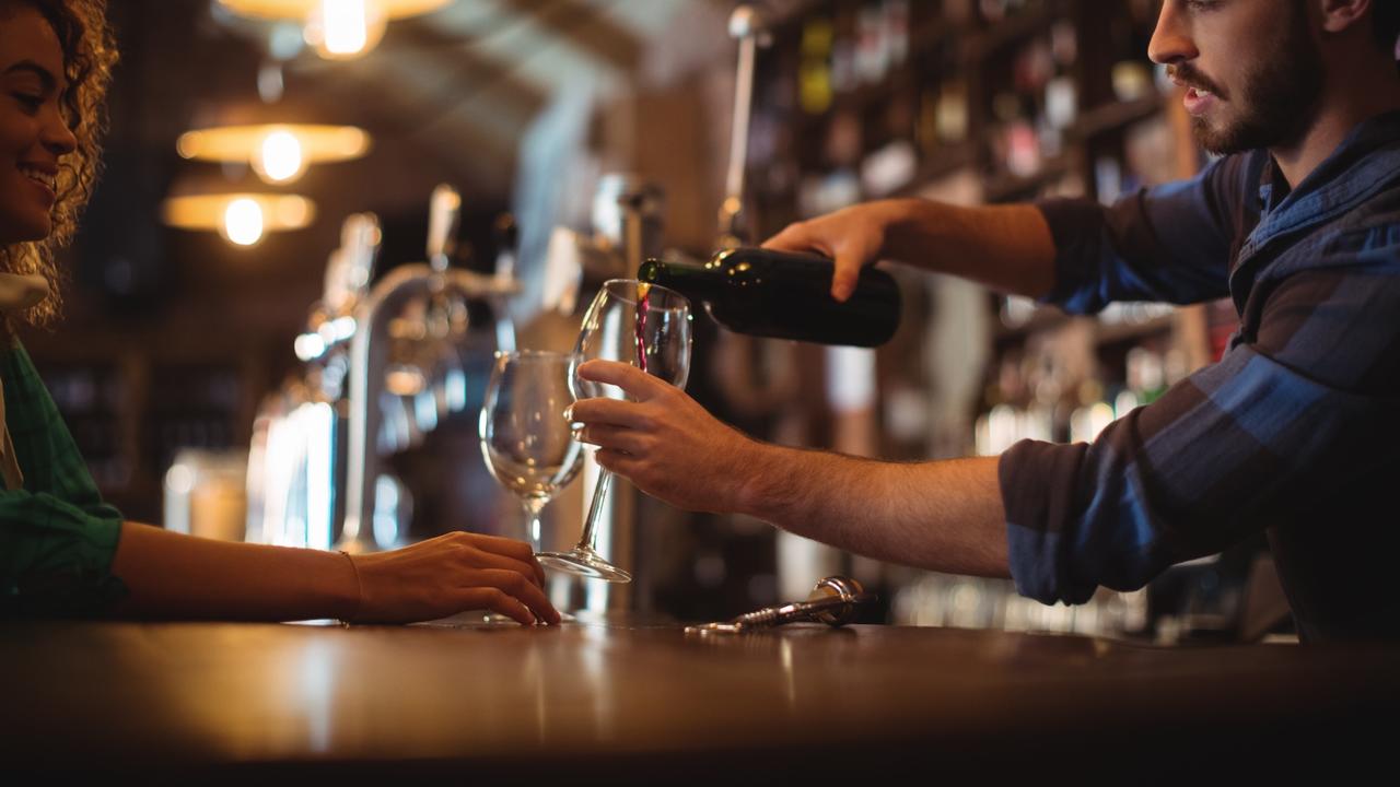 bartender serving glasses of wine