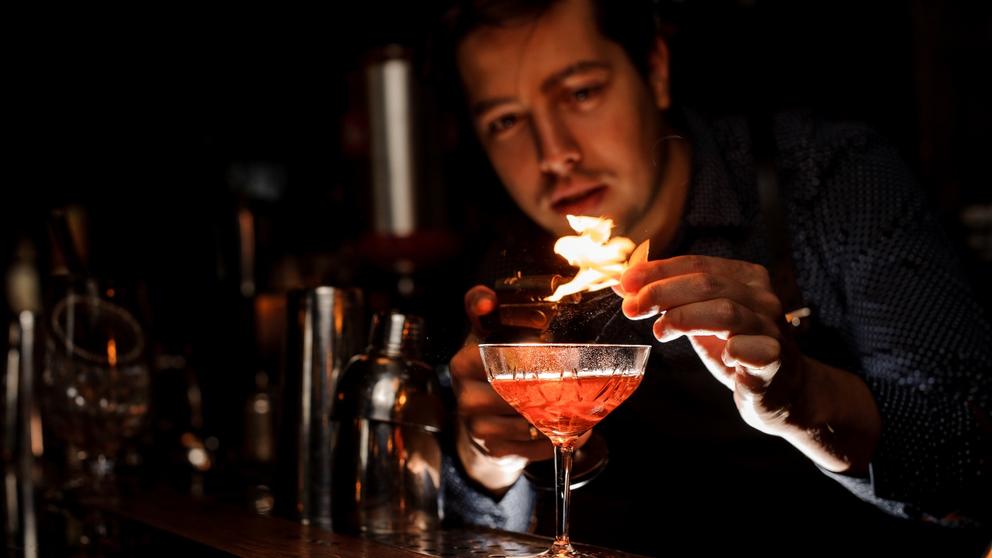 bartender flaming a cocktail
