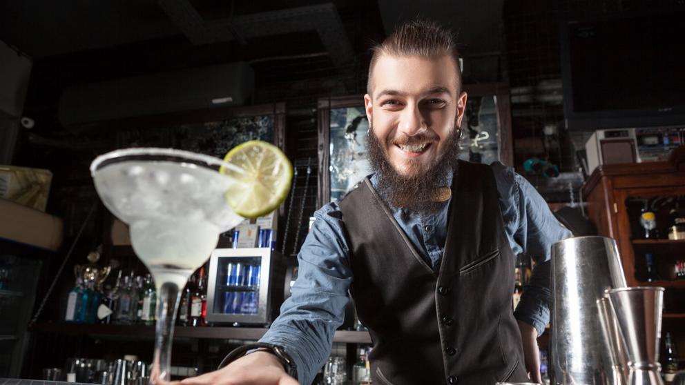 friendly bartender serving cocktail