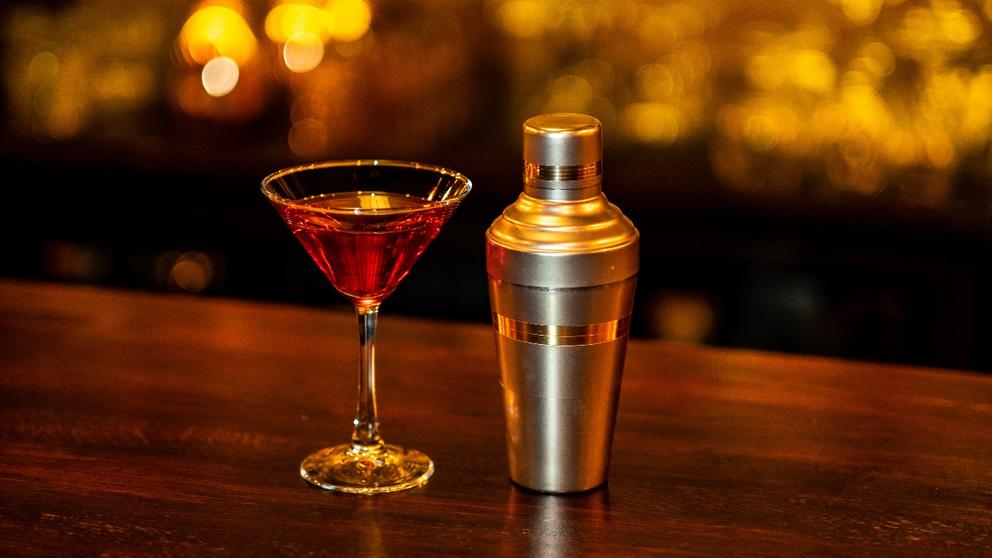 cobbler shaker and cocktail on bar